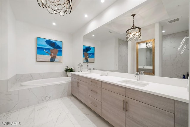 875 6th Ave S Unit 304, Naples, FL 34102 - full bath featuring a chandelier, marble finish floors, recessed lighting, a bath, and double vanity