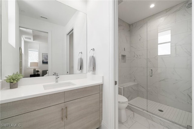 875 6th Ave S Unit 304, Naples, FL 34102 - bathroom with marble finish floors, toilet, a marble finish shower, and vanity