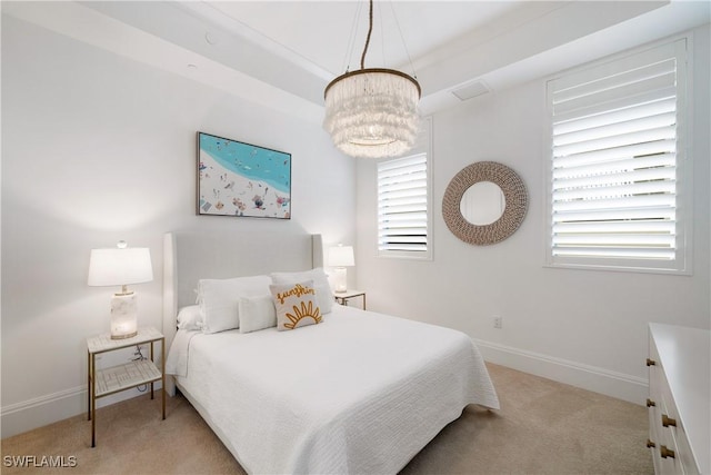 875 6th Ave S Unit 304, Naples, FL 34102 - bedroom with light carpet, a chandelier, and baseboards