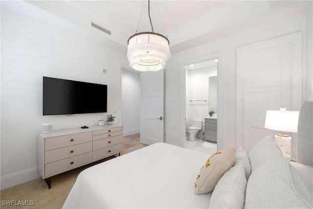 875 6th Ave S Unit 304, Naples, FL 34102 - bedroom with a chandelier, baseboards, ensuite bathroom, and light colored carpet