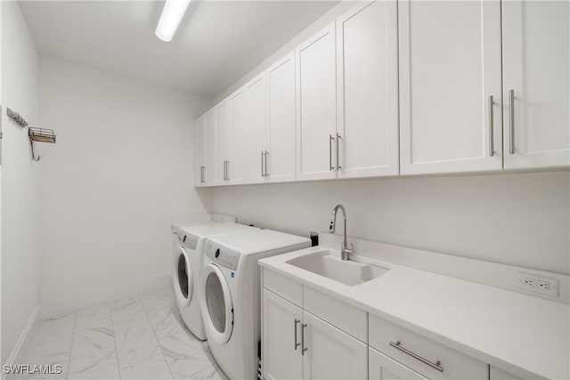 875 6th Ave S Unit 304, Naples, FL 34102 - washroom with cabinet space, washing machine and clothes dryer, light marble finish floors, and baseboards