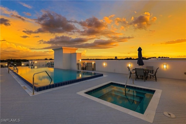 875 6th Ave S Unit 304, Naples, FL 34102 - pool at dusk featuring an outdoor pool and a patio