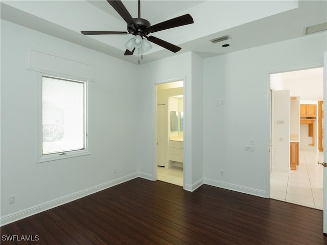 561 Conover Ct, Marco Island, FL 34145 - unfurnished bedroom with wood finished floors, ensuite bathroom, and baseboards
