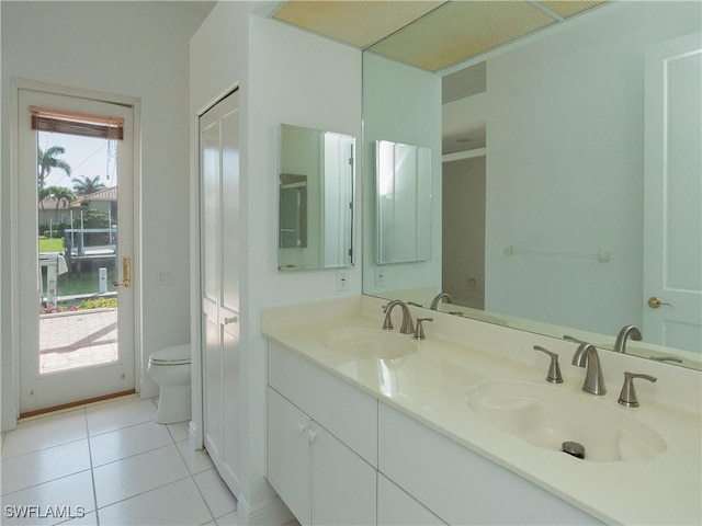 561 Conover Ct, Marco Island, FL 34145 - bathroom featuring double vanity, toilet, and tile patterned flooring