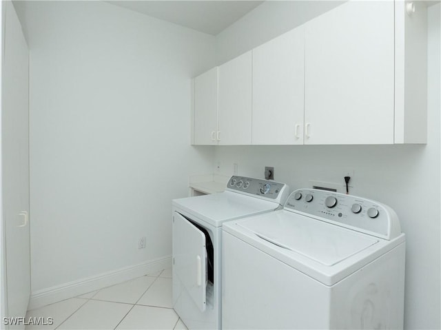 561 Conover Ct, Marco Island, FL 34145 - laundry room featuring cabinet space, separate washer and dryer, baseboards, and light tile patterned floors