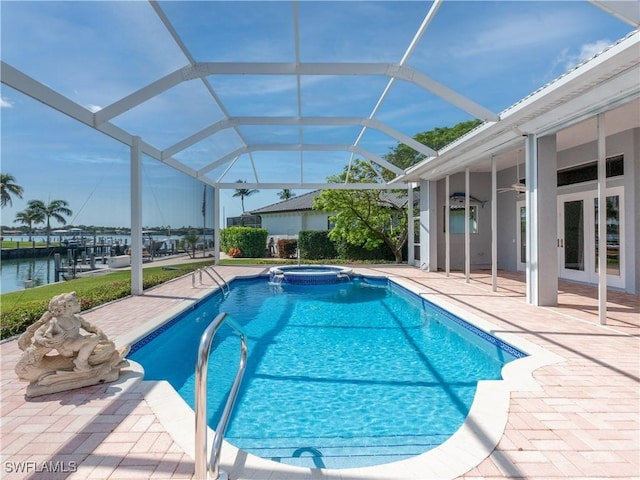 561 Conover Ct, Marco Island, FL 34145 - view of swimming pool with a patio, a pool with connected hot tub, a water view, a ceiling fan, and glass enclosure