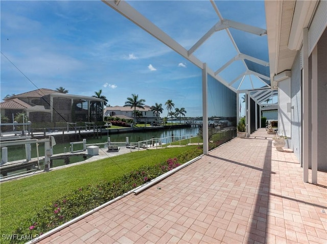 561 Conover Ct, Marco Island, FL 34145 - view of patio featuring a water view, glass enclosure, and a dock