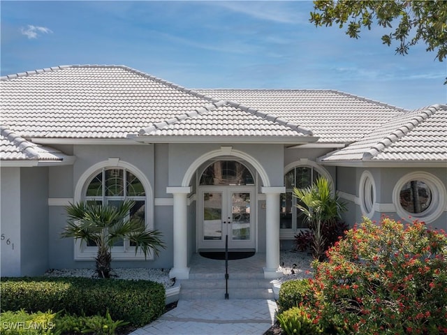 561 Conover Ct, Marco Island, FL 34145 - property entrance with french doors, a tile roof, and stucco siding