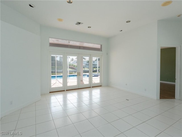 561 Conover Ct, Marco Island, FL 34145 - spare room with french doors, baseboards, light tile patterned flooring, and recessed lighting