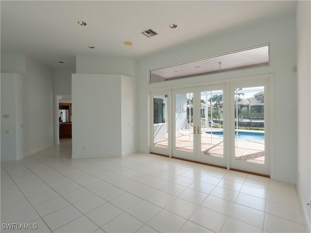 561 Conover Ct, Marco Island, FL 34145 - spare room with french doors, light tile patterned floors, and recessed lighting