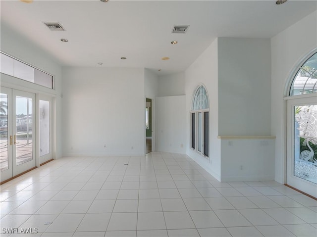 561 Conover Ct, Marco Island, FL 34145 - spare room featuring a towering ceiling, light tile patterned floors, recessed lighting, and baseboards