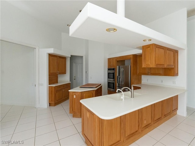 561 Conover Ct, Marco Island, FL 34145 - kitchen featuring appliances with stainless steel finishes, brown cabinets, and light countertops