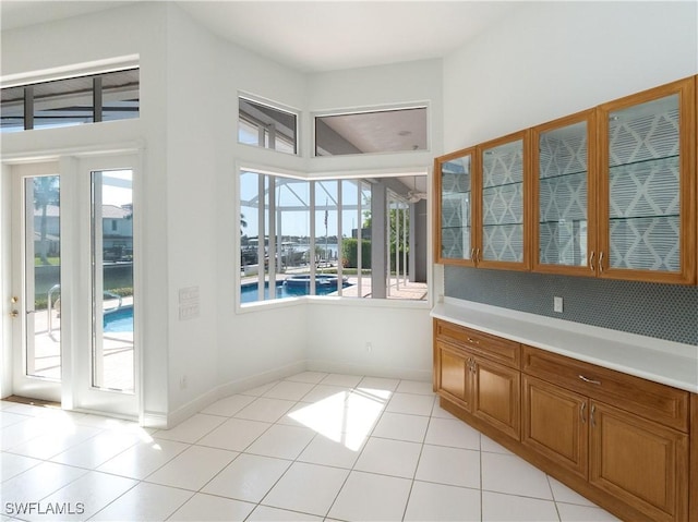 561 Conover Ct, Marco Island, FL 34145 - unfurnished dining area with plenty of natural light, light tile patterned floors, and baseboards