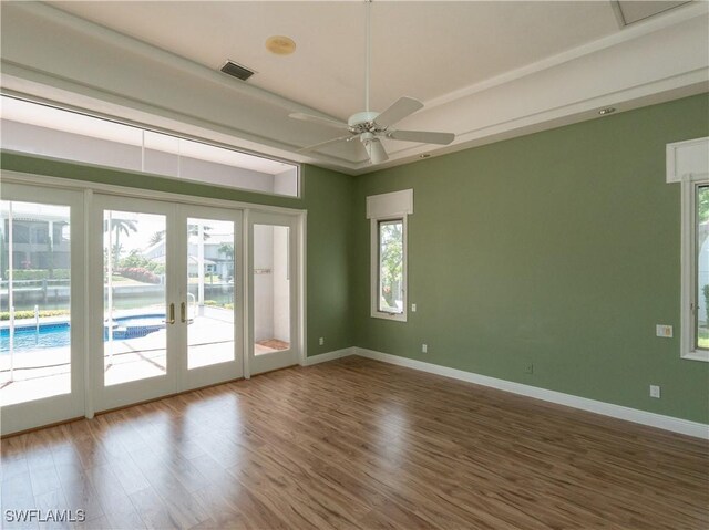 561 Conover Ct, Marco Island, FL 34145 - unfurnished room featuring french doors, wood finished floors, plenty of natural light, and baseboards