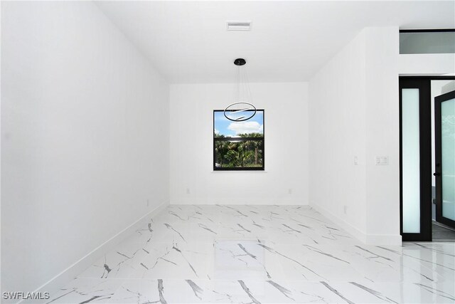 317 Lancelot Ave, Lehigh Acres, FL 33974 - empty room with baseboards and light marble finish floors