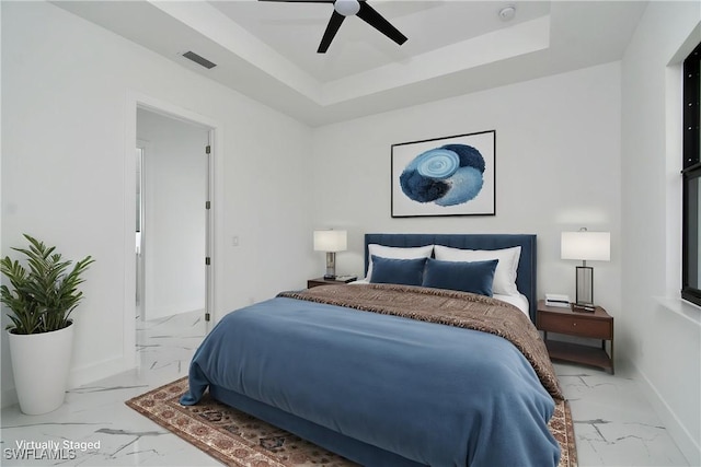 317 Lancelot Ave, Lehigh Acres, FL 33974 - bedroom with light marble finish floors, baseboards, a tray ceiling, and a ceiling fan