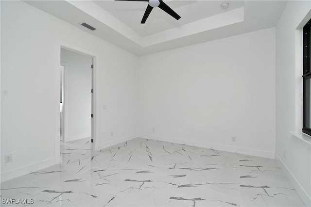 317 Lancelot Ave, Lehigh Acres, FL 33974 - empty room with baseboards, ceiling fan, a tray ceiling, and a smoke detector