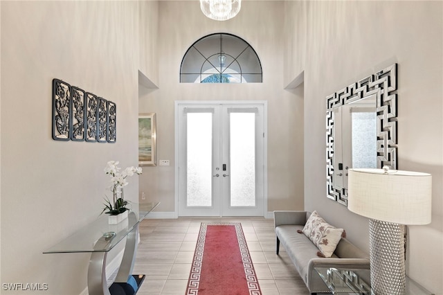 4382 Caldera Cir, Naples, FL 34119 - foyer entrance featuring french doors, light tile patterned floors, healthy amount of natural light, baseboards, and a high ceiling