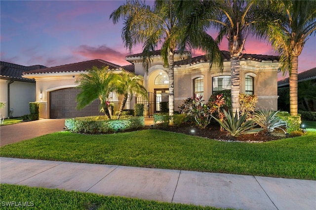 4382 Caldera Cir, Naples, FL 34119 - mediterranean / spanish home featuring stucco siding, driveway, a tile roof, an attached garage, and a yard