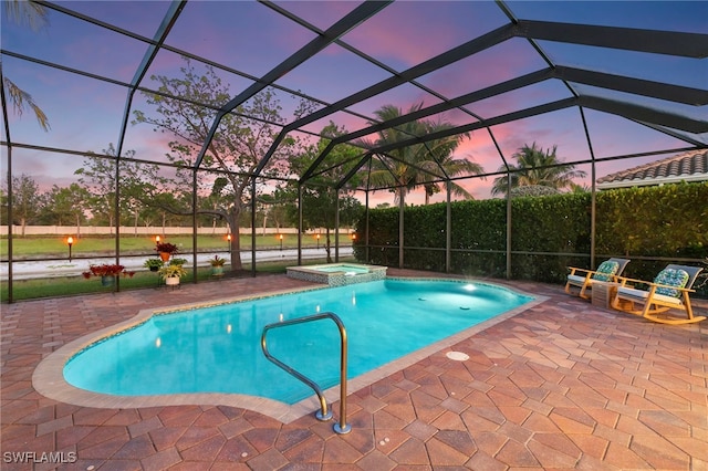4382 Caldera Cir, Naples, FL 34119 - pool at dusk with a patio, a pool with connected hot tub, and glass enclosure