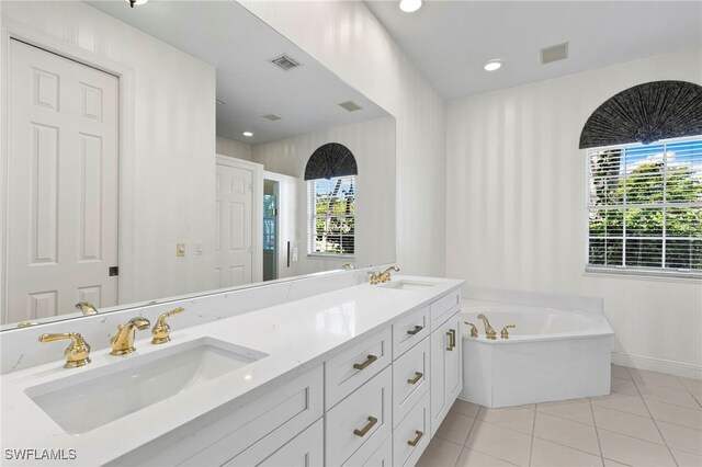 7 Blue Hill Ct, Marco Island, FL 34145 - full bathroom featuring tile patterned flooring, healthy amount of natural light, a bath, and double vanity