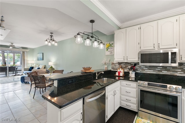 8161 Twelve Oaks Cir Unit 512, Naples, FL 34113 - kitchen with appliances with stainless steel finishes, a sink, a peninsula, and backsplash