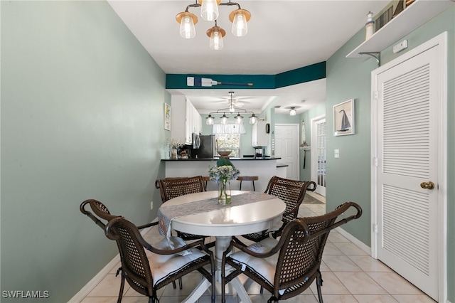 8161 Twelve Oaks Cir Unit 512, Naples, FL 34113 - dining space with light tile patterned floors, a chandelier, baseboards, and a ceiling fan
