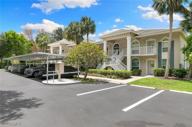 8161 Twelve Oaks Cir Unit 512, Naples, FL 34113 - view of building exterior featuring covered and uncovered parking and stairway