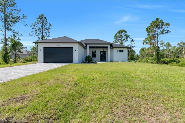 1116 Nimitz Blvd, Lehigh Acres, FL 33974 - prairie-style home with stucco siding, an attached garage, decorative driveway, and a front lawn
