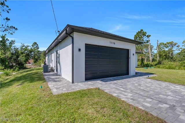 1116 Nimitz Blvd, Lehigh Acres, FL 33974 - garage featuring decorative driveway and cooling unit