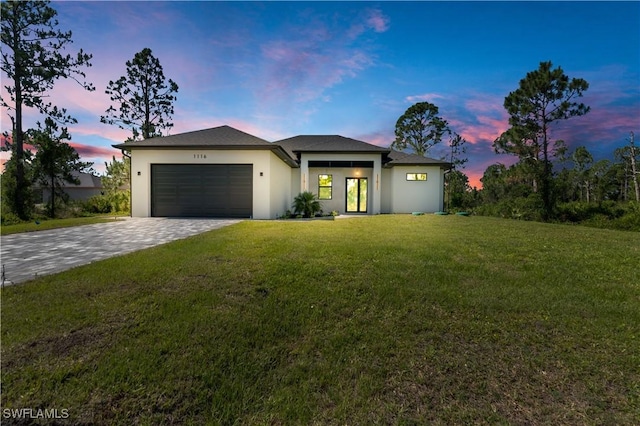 1116 Nimitz Blvd, Lehigh Acres, FL 33974 - view of front of house with a garage, decorative driveway, stucco siding, and a front yard