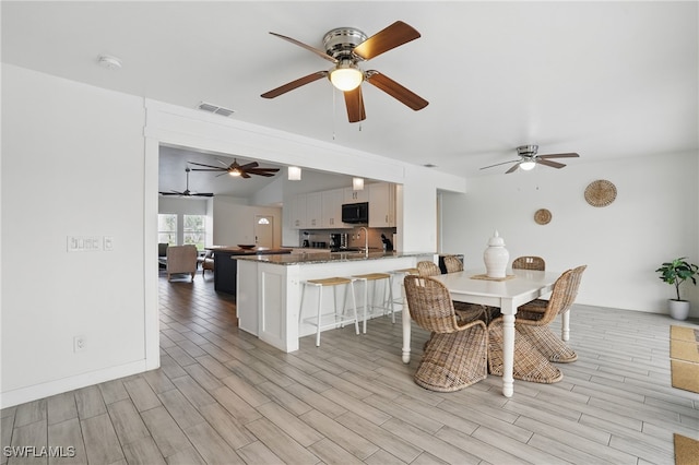 5233 SW 11th Ct, Cape Coral, FL 33914 - dining area featuring ceiling fan, light wood-type flooring, and lofted ceiling