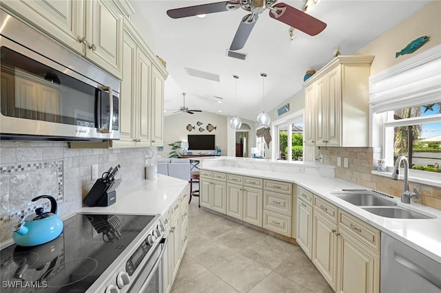 815 Rose Ct, Marco Island, FL 34145 - kitchen with stainless steel appliances, a sink, a ceiling fan, cream cabinets, and open floor plan