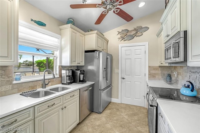 815 Rose Ct, Marco Island, FL 34145 - kitchen with appliances with stainless steel finishes, a sink, a ceiling fan, and tasteful backsplash