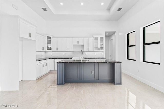 206 Jack Ave N, Lehigh Acres, FL 33971 - kitchen with a sink, white cabinets, a tray ceiling, a kitchen island with sink, and recessed lighting