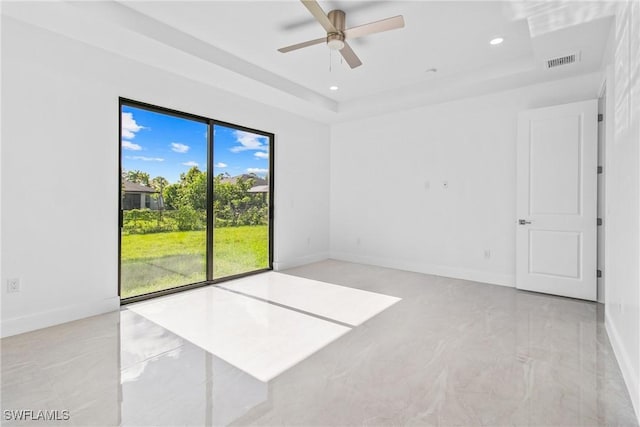 206 Jack Ave N, Lehigh Acres, FL 33971 - spare room with baseboards, a ceiling fan, recessed lighting, a raised ceiling, and light marble finish floors