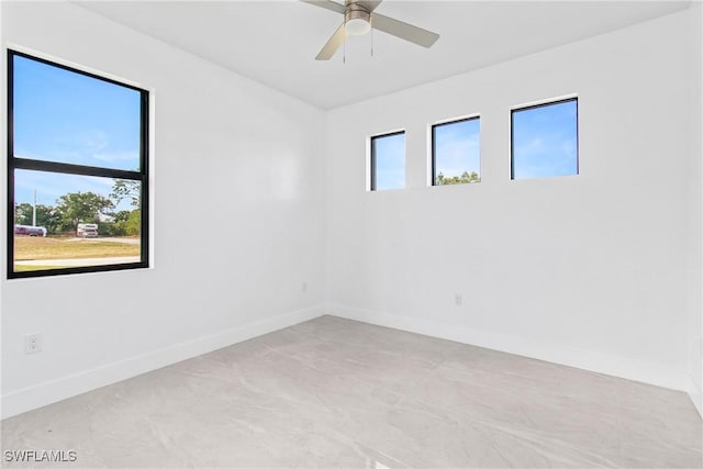 206 Jack Ave N, Lehigh Acres, FL 33971 - spare room featuring plenty of natural light, baseboards, and ceiling fan