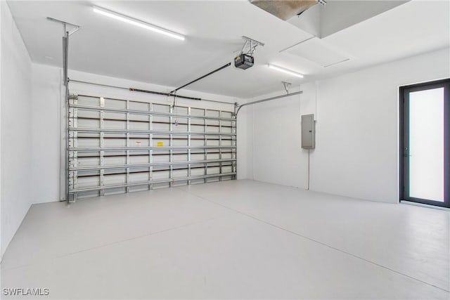206 Jack Ave N, Lehigh Acres, FL 33971 - garage featuring a garage door opener and electric panel