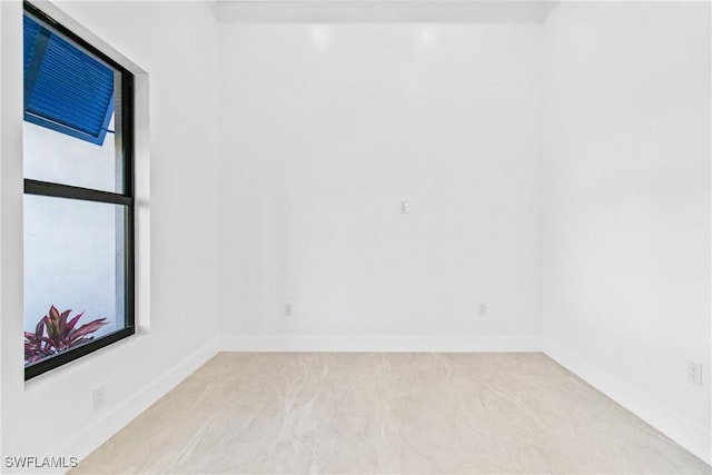 206 Jack Ave N, Lehigh Acres, FL 33971 - spare room featuring baseboards and marble finish floors