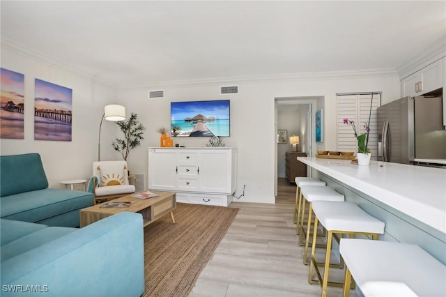 980 7th Ave S Unit 104, Naples, FL 34102 - living area featuring ornamental molding and light wood finished floors