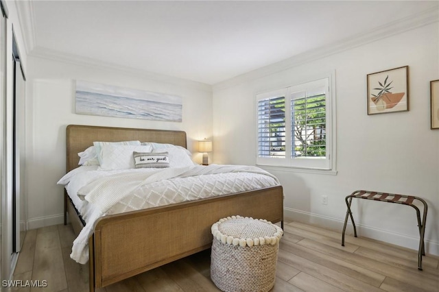 980 7th Ave S Unit 104, Naples, FL 34102 - bedroom with ornamental molding, wood finished floors, and baseboards