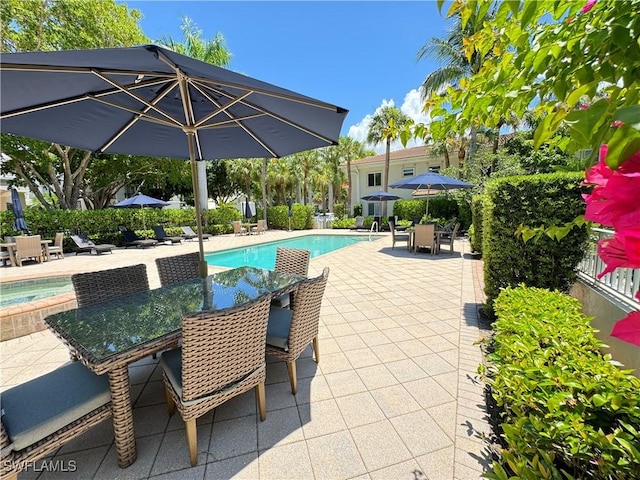 980 7th Ave S Unit 104, Naples, FL 34102 - swimming pool with a patio, outdoor dining area, and an in-ground hot tub