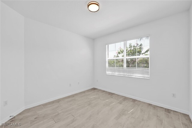 2127 Hamlin St, Naples, FL 34120 - spare room featuring baseboards