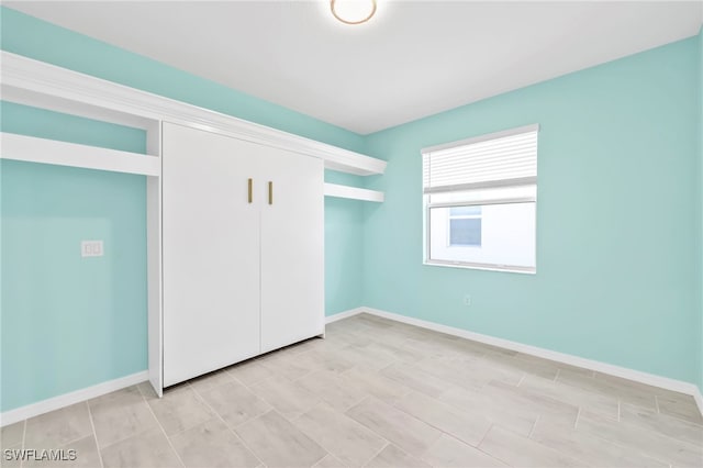 2127 Hamlin St, Naples, FL 34120 - unfurnished bedroom with a closet and baseboards