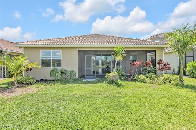 2127 Hamlin St, Naples, FL 34120 - back of property with stucco siding, a tile roof, a lawn, and a sunroom