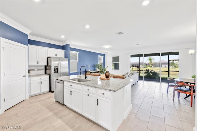 2127 Hamlin St, Naples, FL 34120 - kitchen featuring a sink, appliances with stainless steel finishes, ornamental molding, an island with sink, and open floor plan