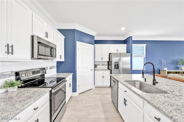 2127 Hamlin St, Naples, FL 34120 - kitchen with stainless steel appliances, a sink, backsplash, white cabinets, and ornamental molding