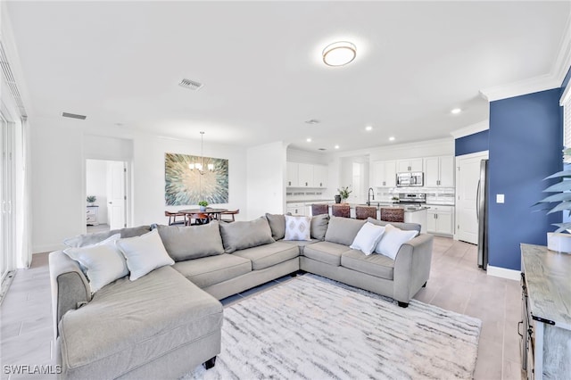 2127 Hamlin St, Naples, FL 34120 - living area with a chandelier, recessed lighting, crown molding, and baseboards