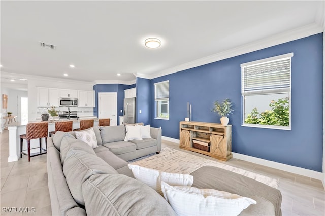 2127 Hamlin St, Naples, FL 34120 - living area with crown molding, recessed lighting, plenty of natural light, baseboards, and light tile patterned flooring