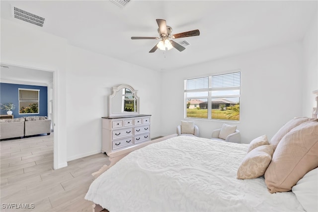 2127 Hamlin St, Naples, FL 34120 - bedroom with baseboards, wood finished floors, and a ceiling fan